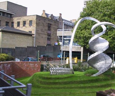 a silver sculpture in the shape of dna